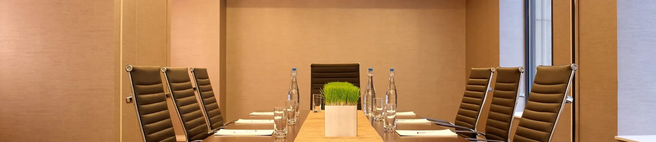 A conference room with a long table and chairs